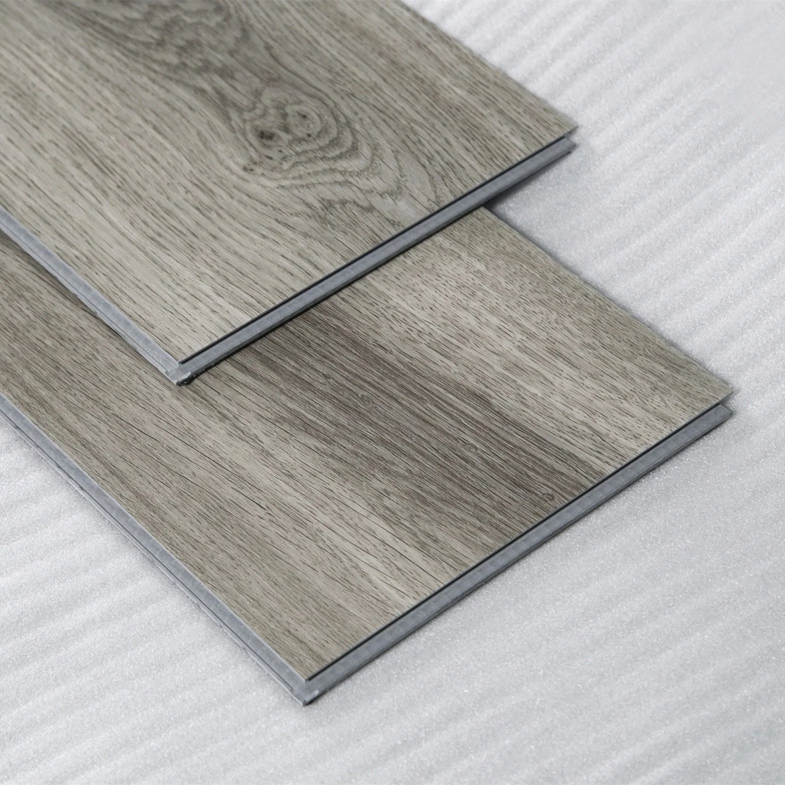 Revêtement de sol stratifié en vinyle PVC Lvt Spc Click ignifuge, imperméable et durable pour la décoration commerciale.