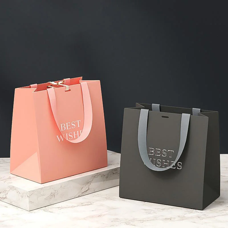 Bolsas de regalo de papel de lujo para boutiques con asas de cinta y logotipo