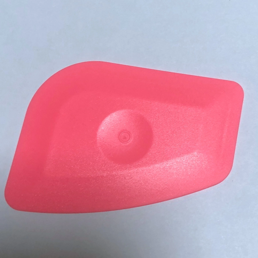 Petite raclette en plastique rose pour le vinyle