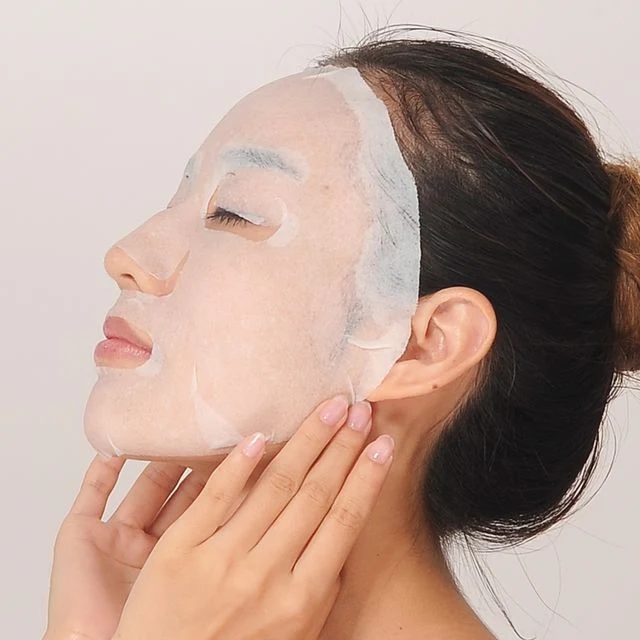 Machine d'emballage de masques faciaux pour plier et ensacher des feuilles de masques de beauté.