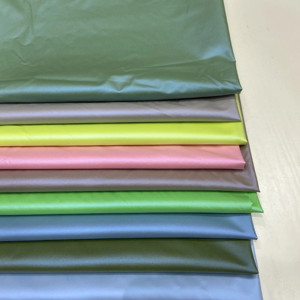 Light Bright Pearlescent Film Coated Polyester Pongee Fabric with Release Paper PU Transfer Coating for Down Jackets and Apparel