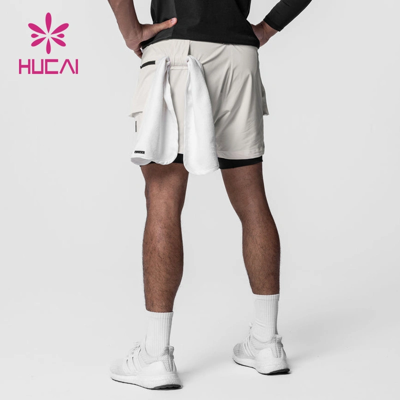 OEM ODM Personnalisé à la mode Fonctionnel de haute qualité Course Fitness Gym Lâche Actif Athlétique Superposé Fermeture éclair Cargo Hommes 2 en 1 Shorts de sport.