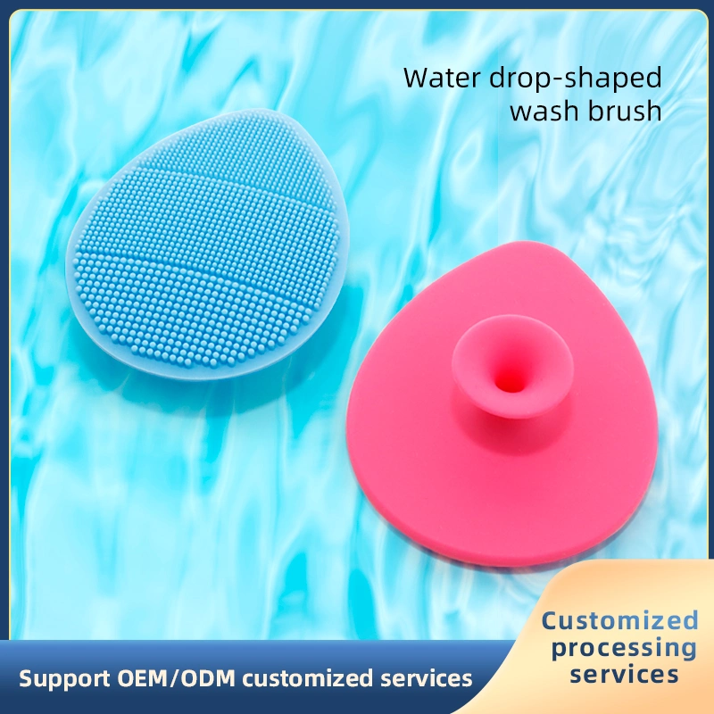 Usine personnalisée en gros Brosse de bain en silicone Outils de beauté de nettoyage du visage Forme de goutte d'eau douce Matériau nano Brosse en silicone antibactérienne de nettoyage