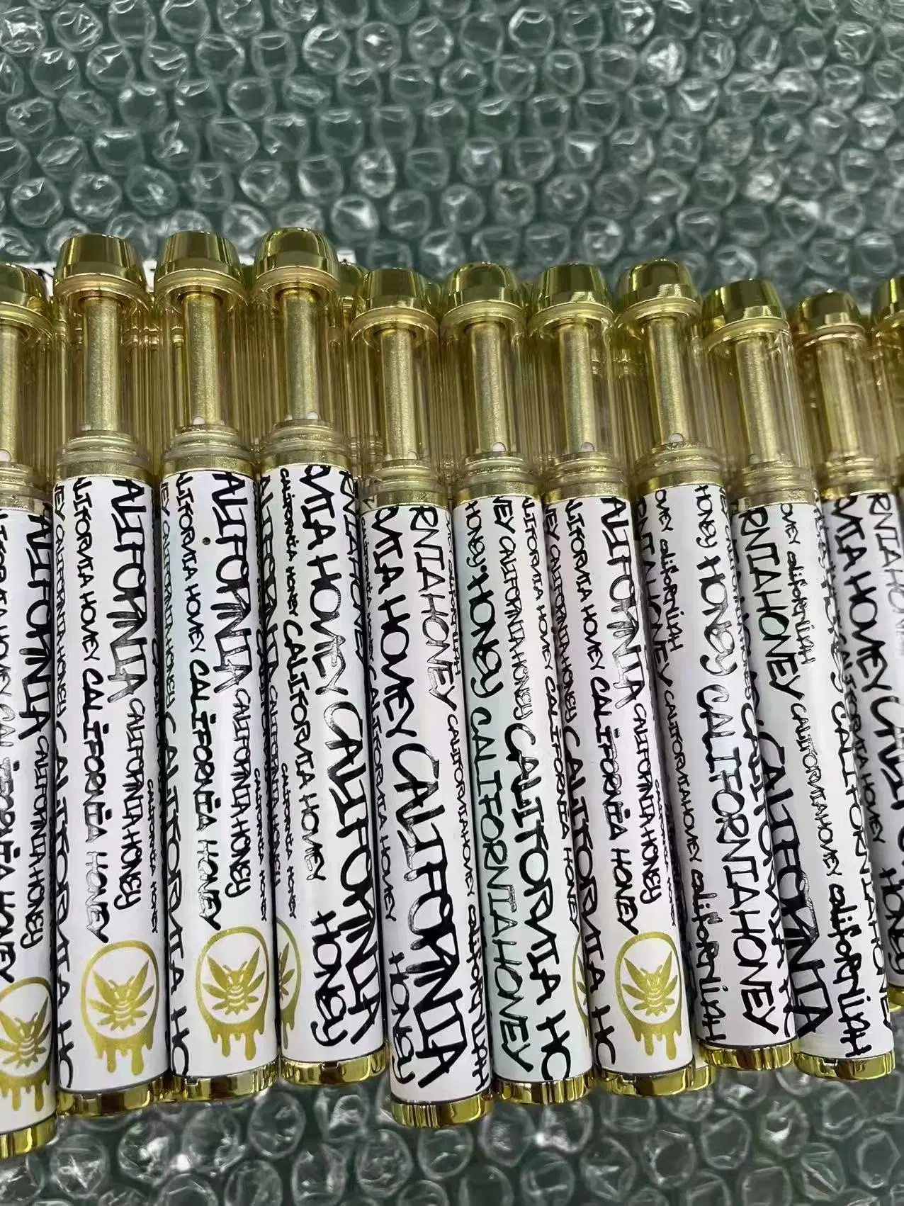 Batería recargable de pluma de Vape Mayorista/Proveedor California Miel Vape plumas de oro de la bobina de cerámica de 1ml de aceite espeso cartuchos