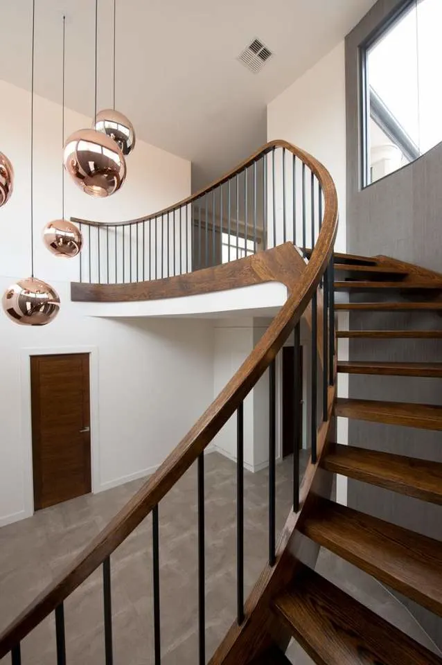 Interior Curved Staircase with Wrought Iron Balustrade