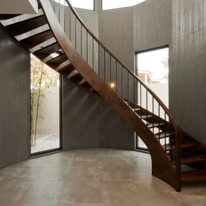 Interior Curved Staircase with Wrought Iron Balustrade