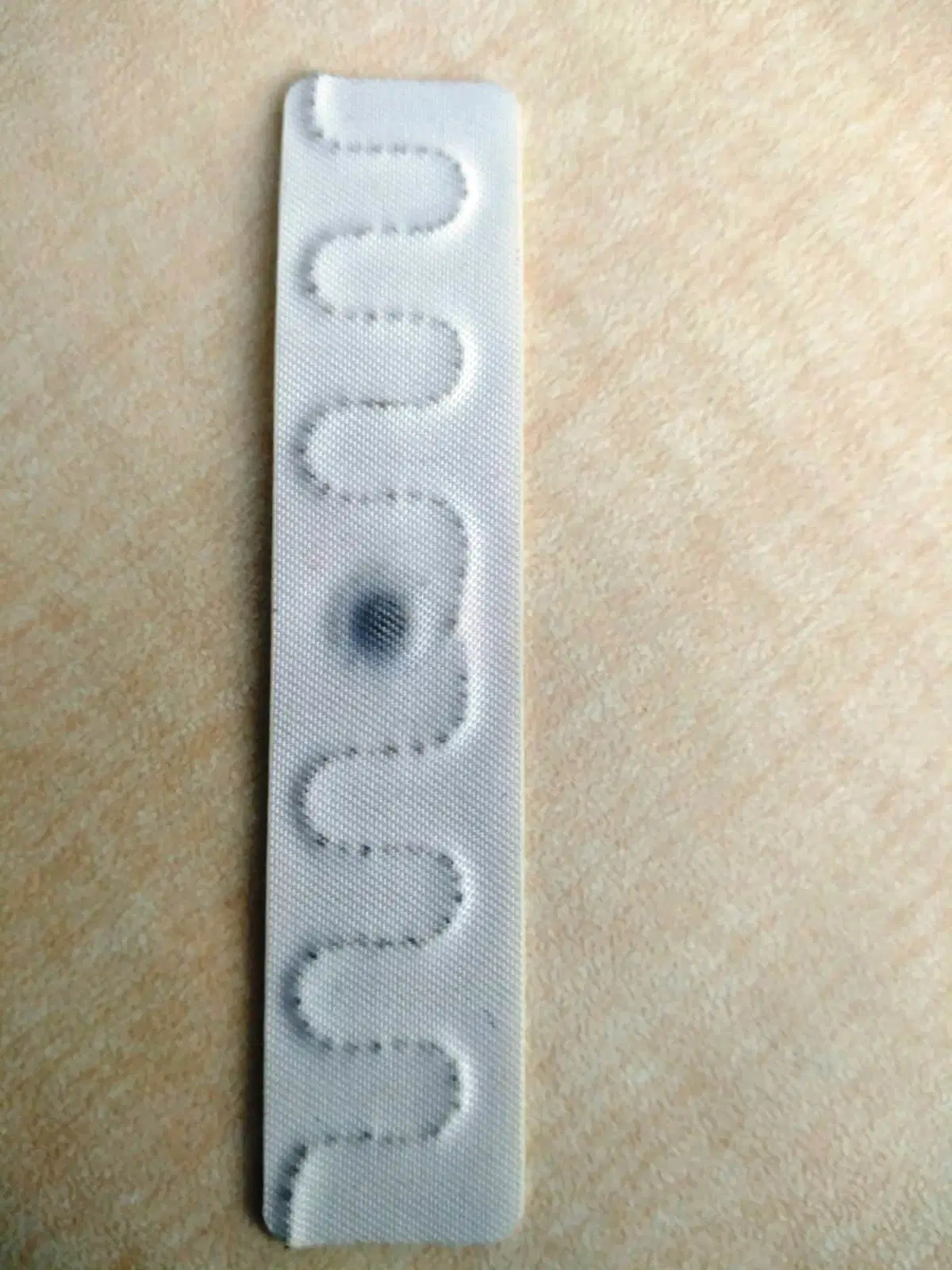 RFID Label Laundry Tag with Adhesive Backing Installed by Hot Pressing