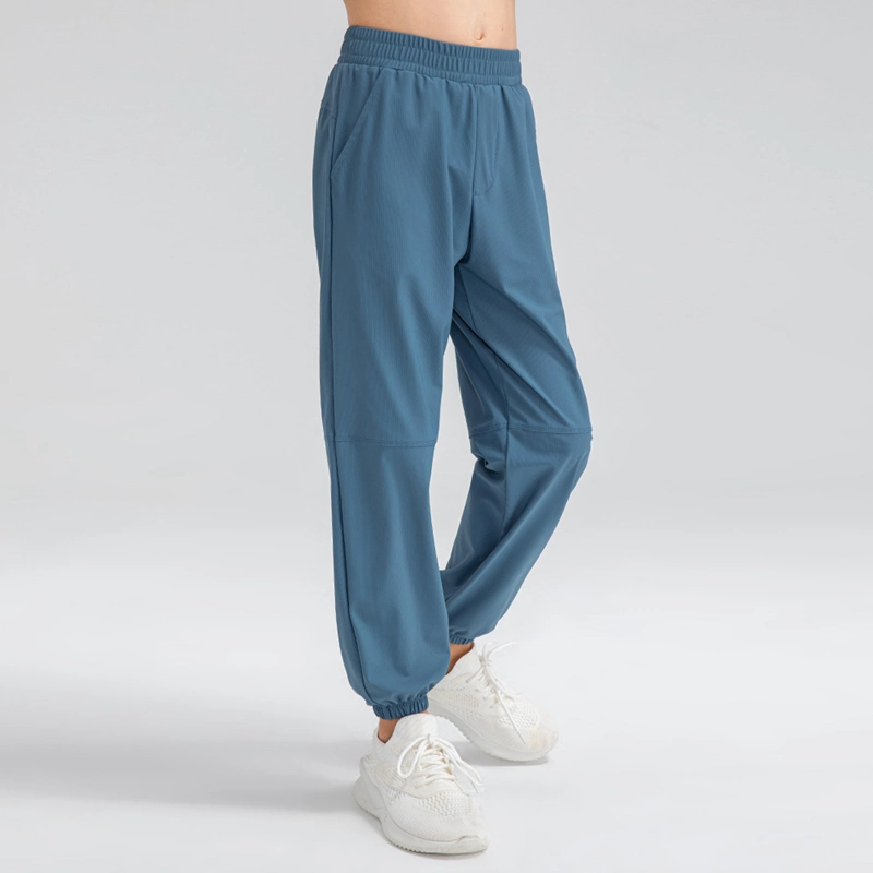 Pantalón de chándal informal de ajuste holgado con bolsillos laterales ligero para jóvenes Pantalón deportivo activo de secado rápido para niños